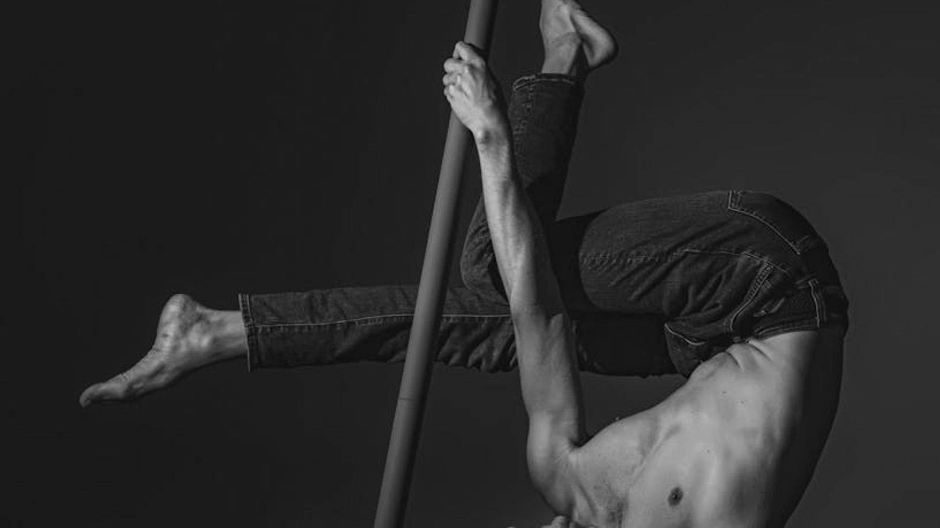 Man performing a controlled strength exercise in a minimalist gym setting.